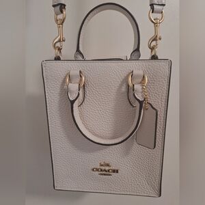 Small white Coach crossbody bag